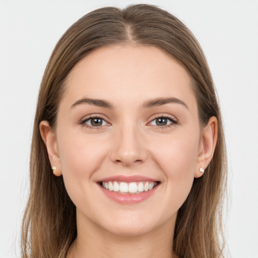 Joyful white young-adult female with long  brown hair and grey eyes