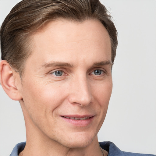 Joyful white adult male with short  brown hair and grey eyes