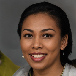 Joyful latino young-adult female with short  brown hair and brown eyes