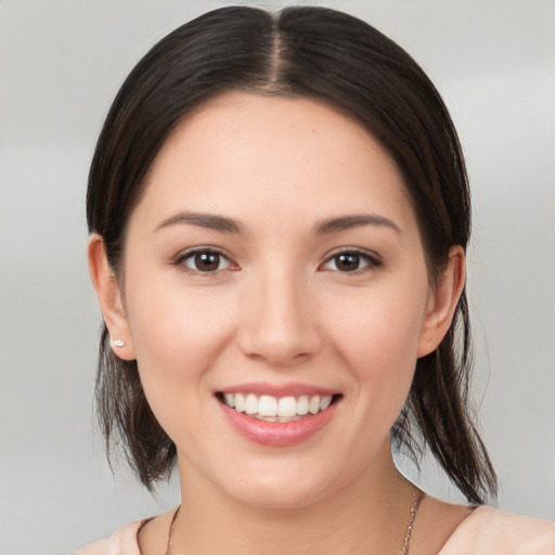 Joyful white young-adult female with medium  brown hair and brown eyes