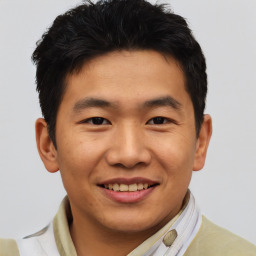 Joyful asian young-adult male with short  brown hair and brown eyes