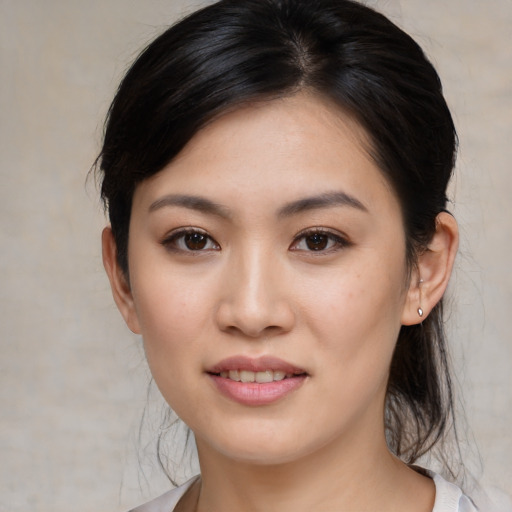 Joyful white young-adult female with medium  black hair and brown eyes