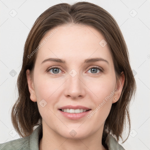 Joyful white young-adult female with medium  brown hair and grey eyes