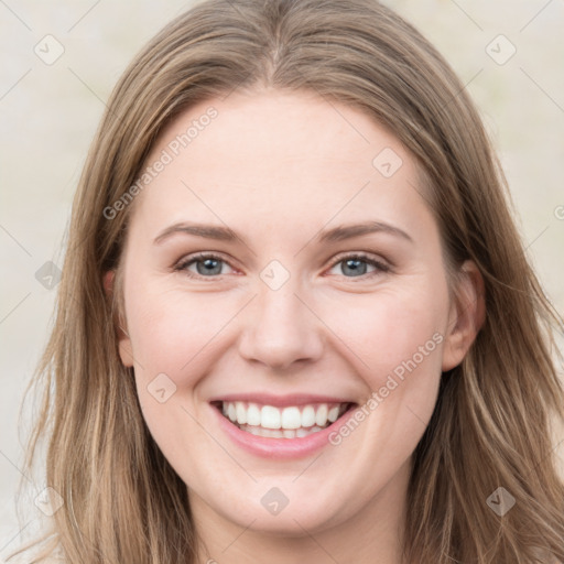 Joyful white young-adult female with long  brown hair and grey eyes