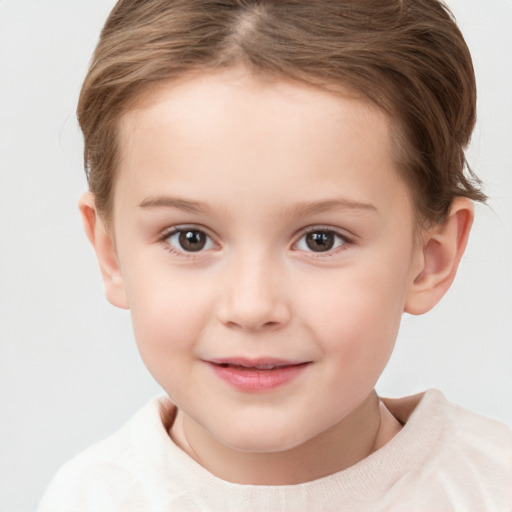 Joyful white child female with short  brown hair and brown eyes