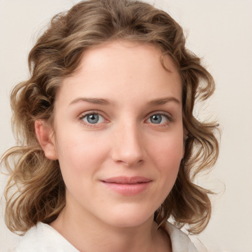 Joyful white young-adult female with medium  brown hair and blue eyes