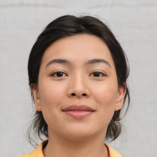 Joyful asian young-adult female with medium  brown hair and brown eyes