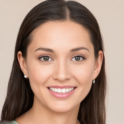 Joyful white young-adult female with long  brown hair and brown eyes