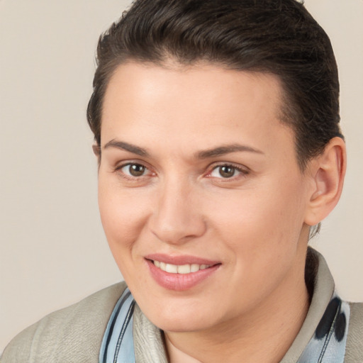 Joyful white young-adult female with short  brown hair and brown eyes