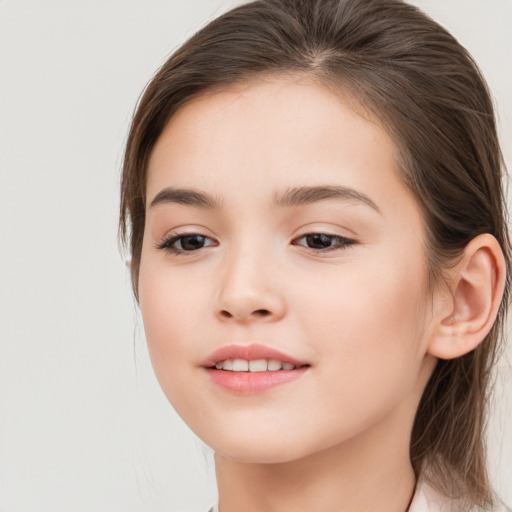 Joyful white child female with long  brown hair and brown eyes