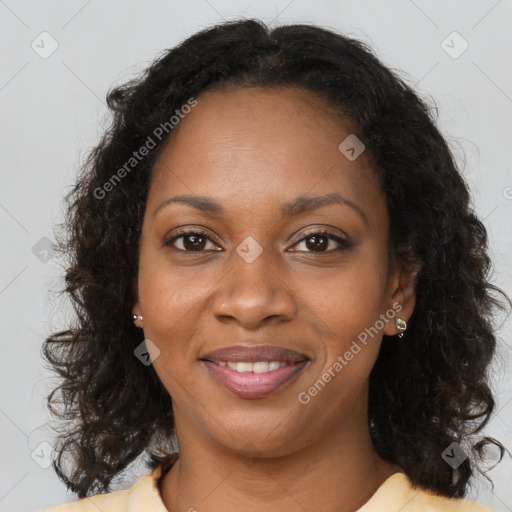 Joyful black young-adult female with long  brown hair and brown eyes