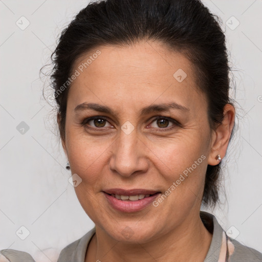 Joyful white adult female with medium  brown hair and brown eyes