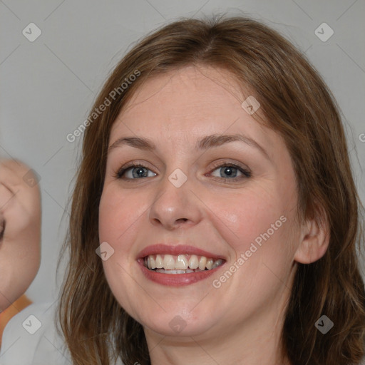 Joyful white young-adult female with medium  brown hair and blue eyes