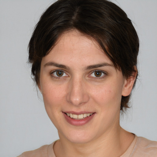 Joyful white young-adult female with medium  brown hair and brown eyes