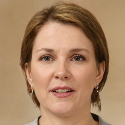 Joyful white adult female with medium  brown hair and grey eyes