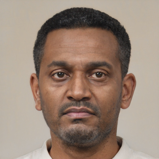 Neutral latino adult male with short  black hair and brown eyes