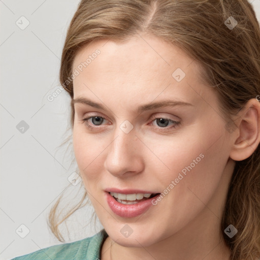 Joyful white young-adult female with medium  brown hair and blue eyes