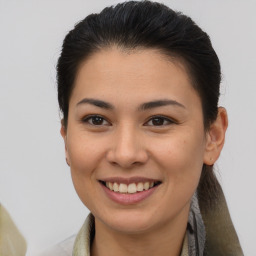 Joyful latino young-adult female with medium  brown hair and brown eyes