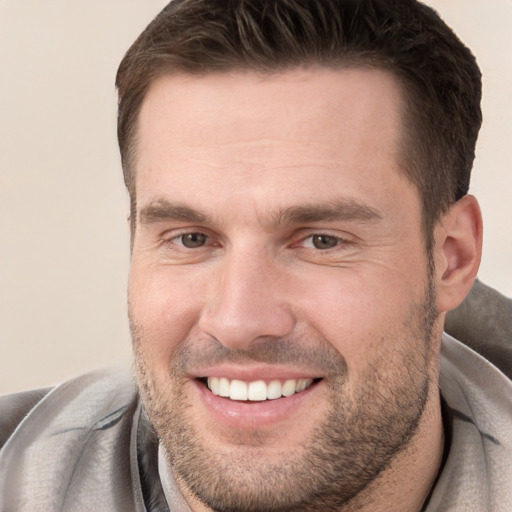 Joyful white young-adult male with short  brown hair and brown eyes