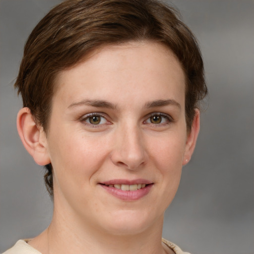 Joyful white young-adult female with short  brown hair and grey eyes