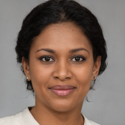 Joyful black young-adult female with medium  brown hair and brown eyes