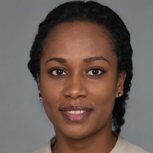 Joyful black young-adult female with medium  black hair and brown eyes