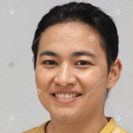 Joyful latino young-adult male with short  brown hair and brown eyes
