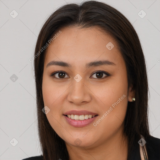 Joyful latino young-adult female with long  brown hair and brown eyes