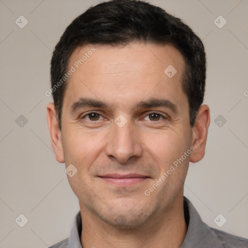 Joyful white adult male with short  black hair and brown eyes