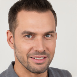 Joyful white young-adult male with short  brown hair and brown eyes