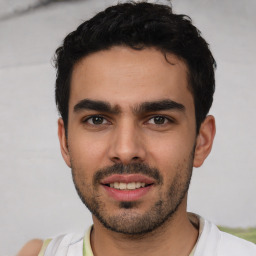 Joyful white young-adult male with short  black hair and brown eyes