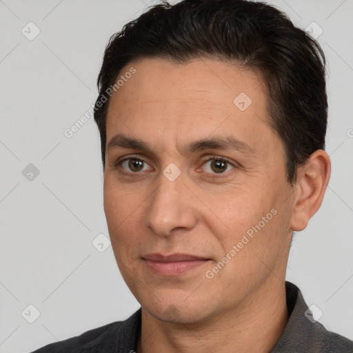 Joyful white adult male with short  brown hair and brown eyes