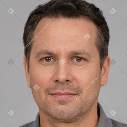 Joyful white adult male with short  brown hair and brown eyes