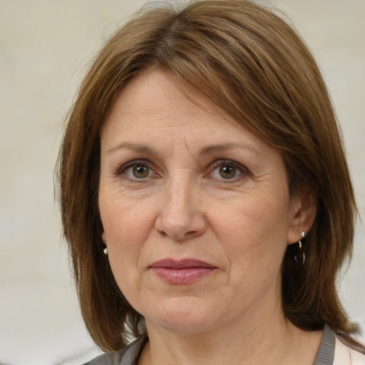 Joyful white adult female with medium  brown hair and brown eyes