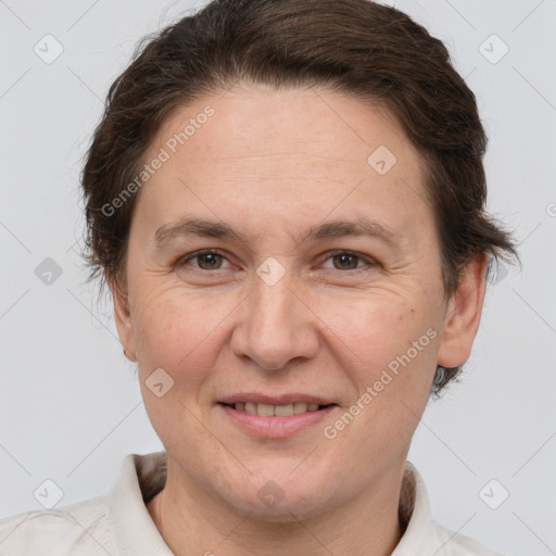 Joyful white adult female with short  brown hair and brown eyes