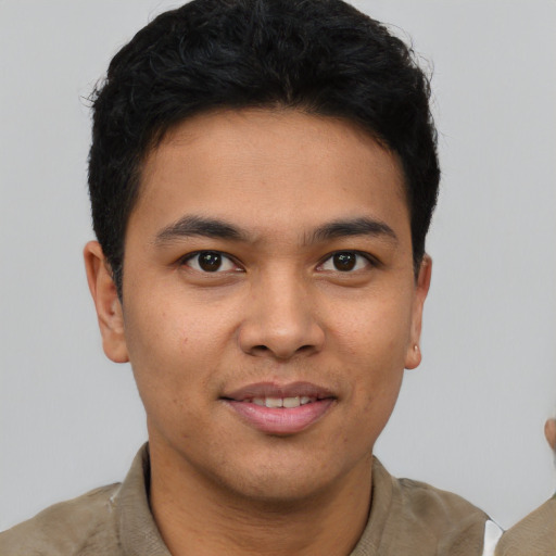 Joyful asian young-adult male with short  brown hair and brown eyes