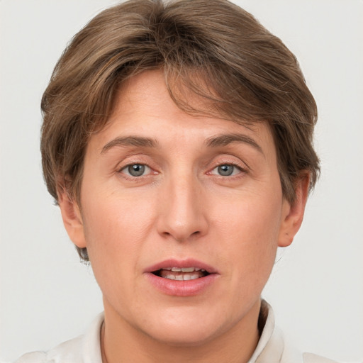 Joyful white adult female with short  brown hair and grey eyes