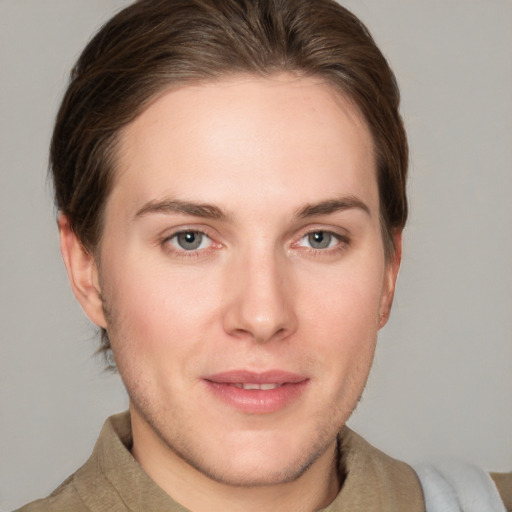 Joyful white young-adult female with short  brown hair and grey eyes