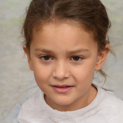 Joyful white child female with short  brown hair and brown eyes