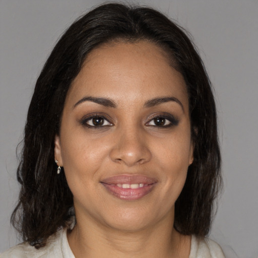 Joyful black young-adult female with medium  brown hair and brown eyes