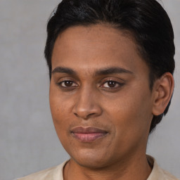 Joyful latino young-adult male with short  brown hair and brown eyes