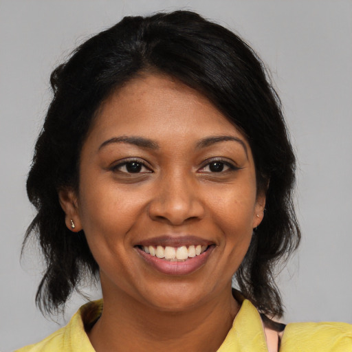 Joyful black young-adult female with medium  black hair and brown eyes