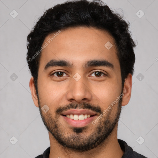 Joyful latino young-adult male with short  black hair and brown eyes