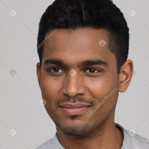 Joyful black young-adult male with short  black hair and brown eyes