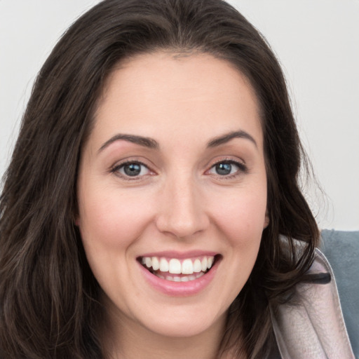 Joyful white young-adult female with long  brown hair and blue eyes