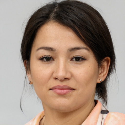 Joyful asian young-adult female with medium  brown hair and brown eyes