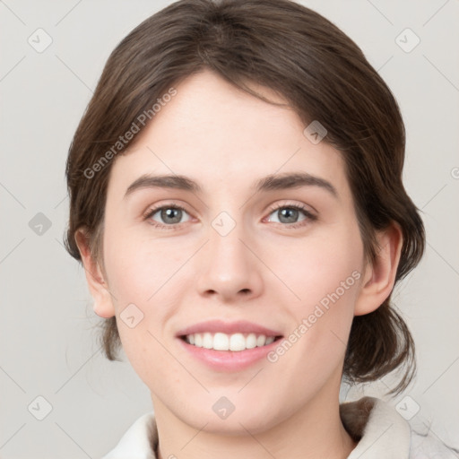 Joyful white young-adult female with medium  brown hair and grey eyes