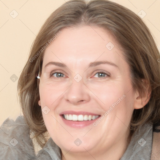 Joyful white adult female with medium  brown hair and blue eyes