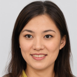 Joyful white young-adult female with long  brown hair and brown eyes