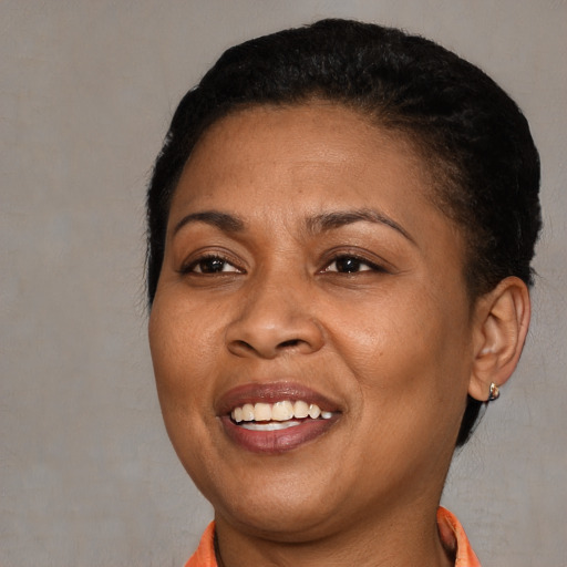 Joyful black adult female with short  brown hair and brown eyes